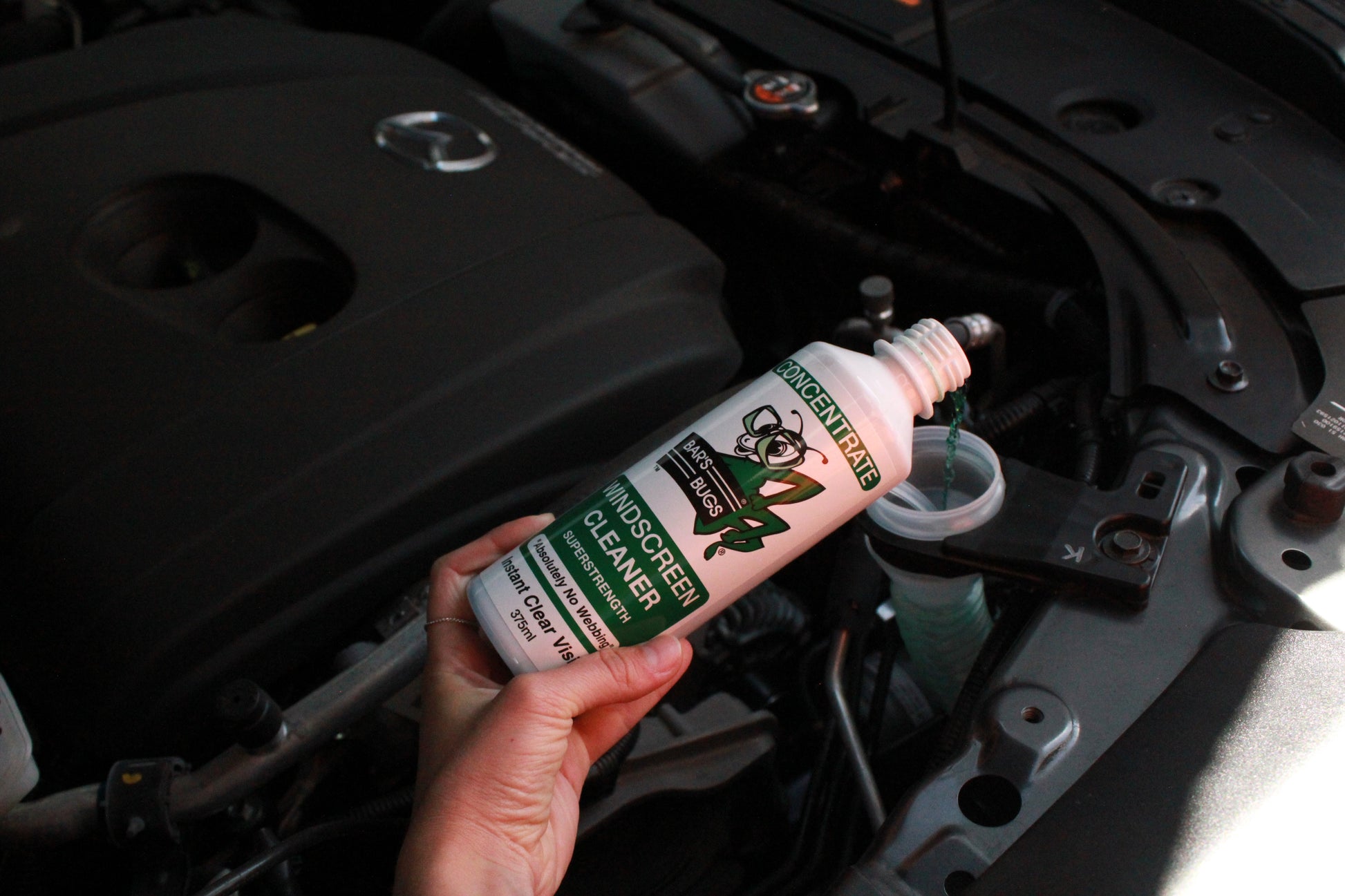 Pouring 375ml Windscreen Cleaner into Reservoir Bar's Bugs